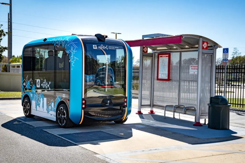 Autonomous electric shuttle at a transit stop